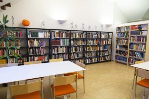 Kirjaston nurkkaus, jossa kirjahyllyjä ja työskentelypaikkoja.