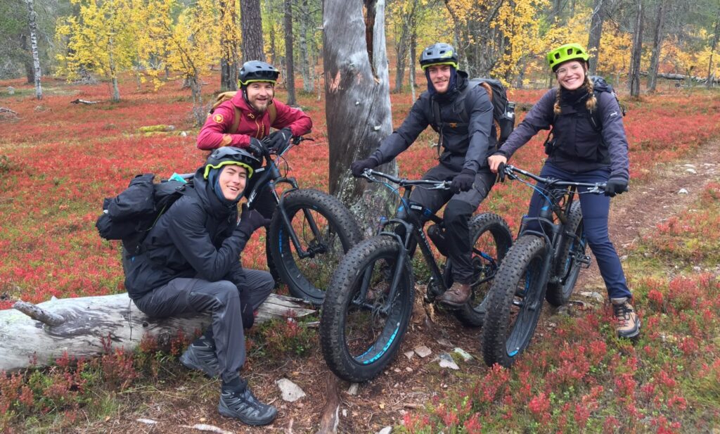 People in a Autumn forest with their Fatbikes.