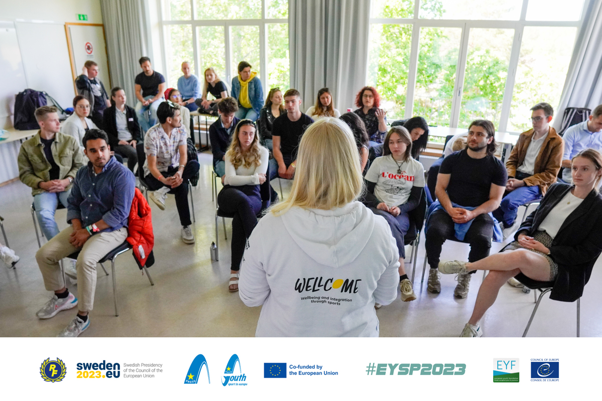 people listen to the person with their back to the camera.