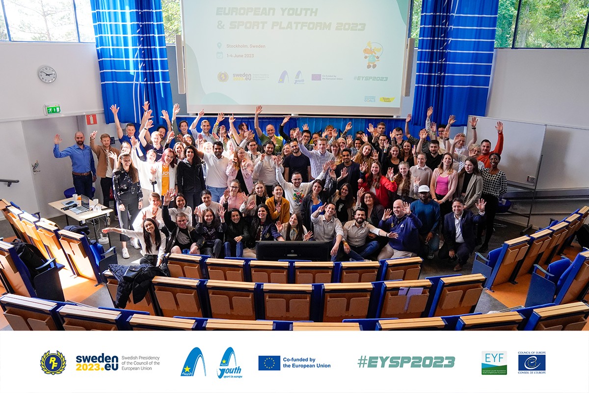 People in a group photo on stage.