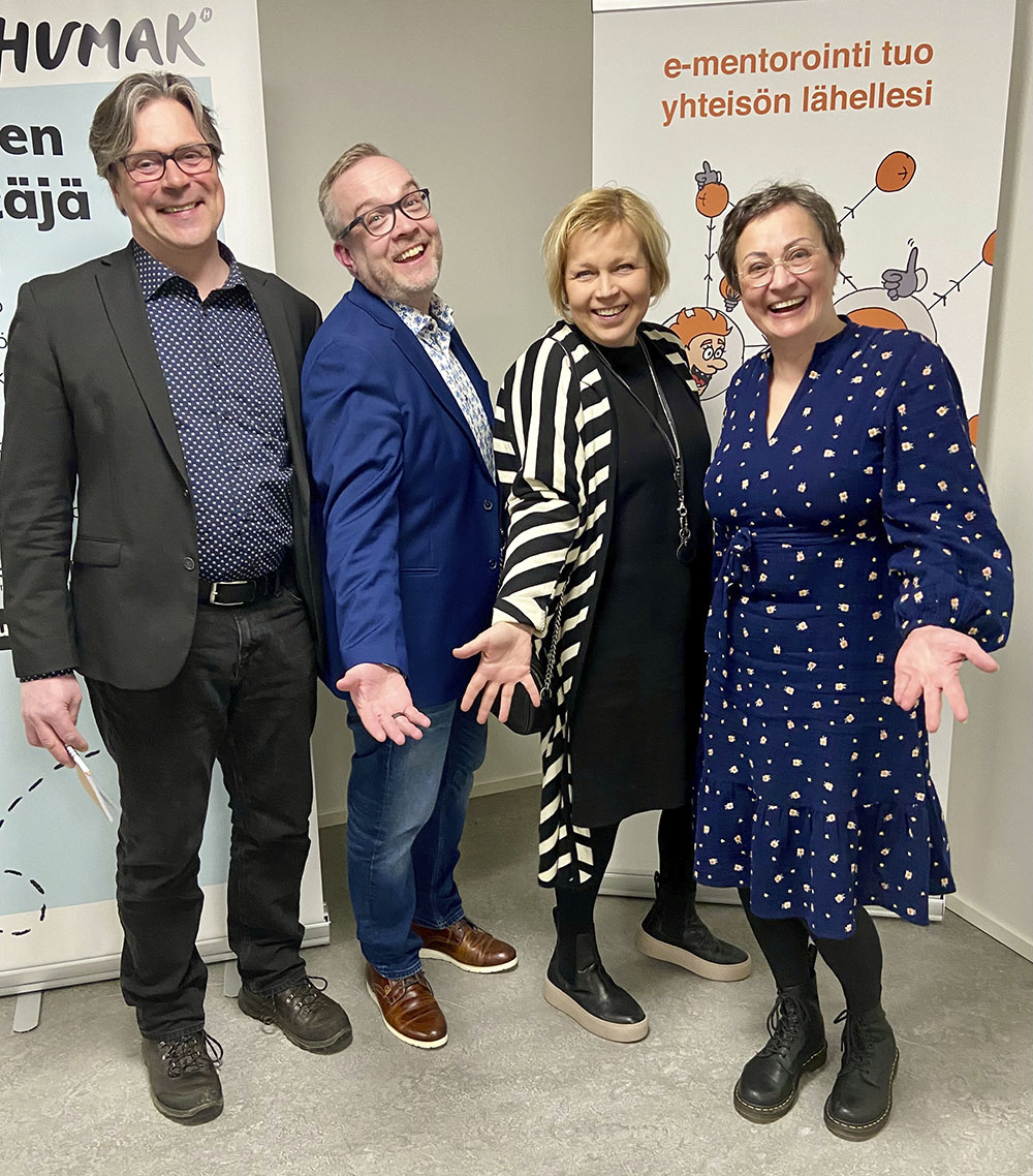 Four Humak board members smiling to the camera. They are in a good mood, ready for the audit.