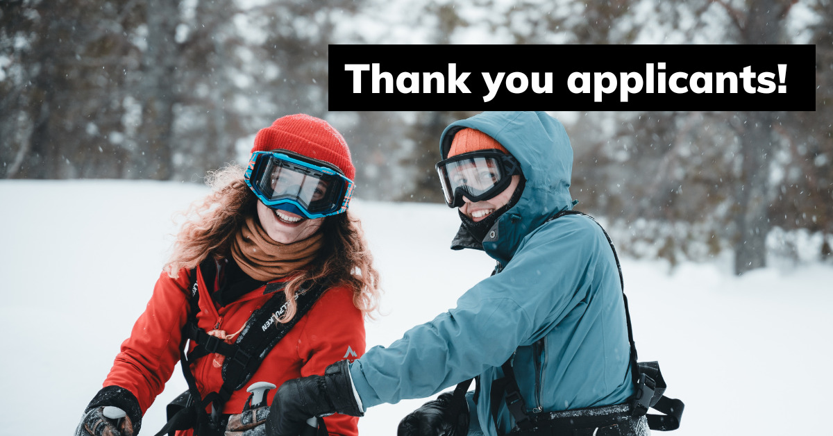Two female students smiling in a snowy Finnish landscape. They are wearing ski masks and their hands are busy with climbing ropes.