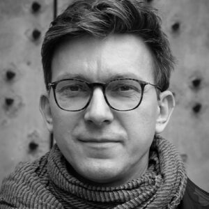 Man with the glasses.