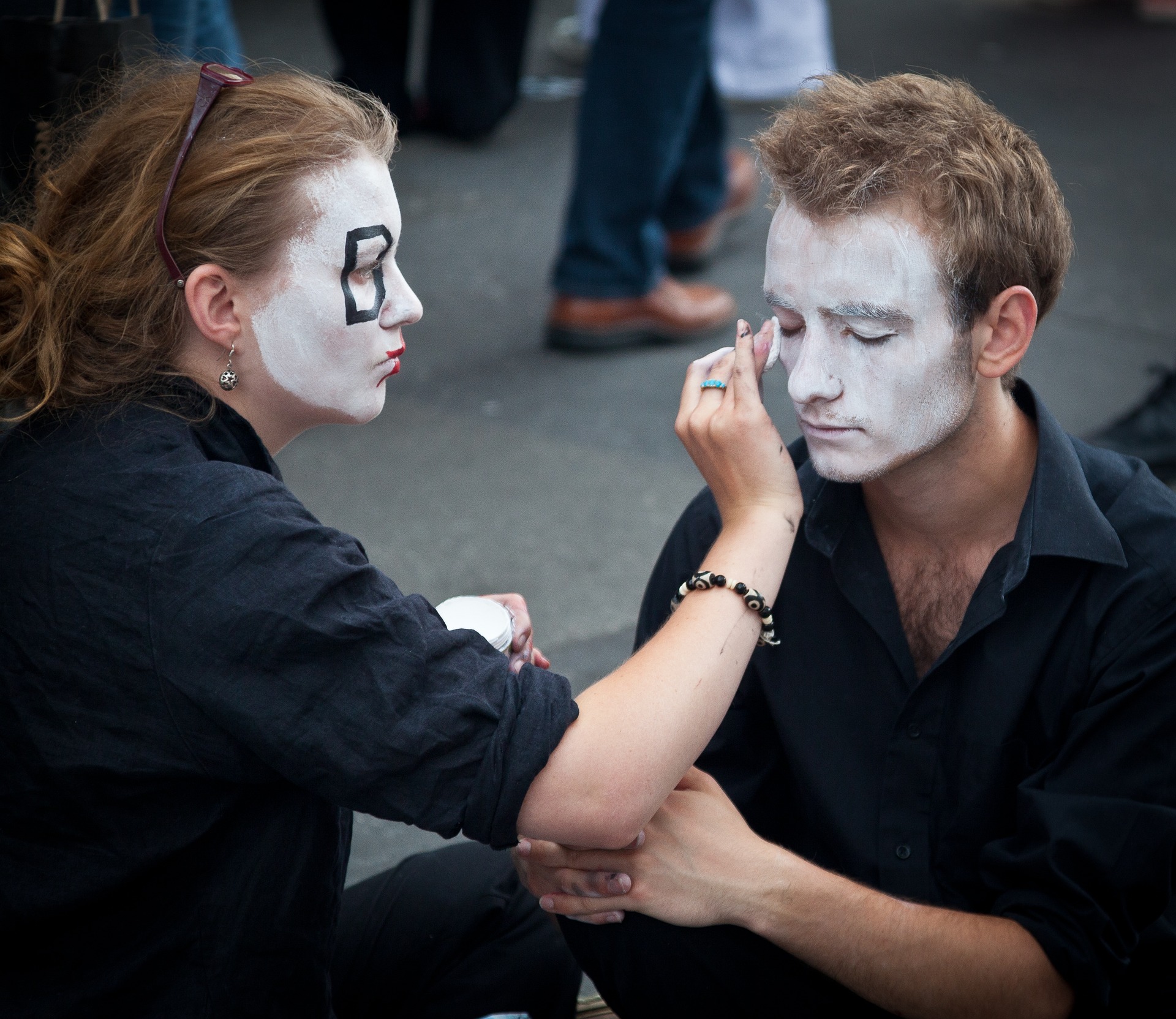 Young street performers getting ready for their role