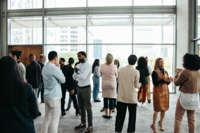 Corporate crowd showcasing teamwork and networking during a business event in a contemporary office setting. Professional and collaborative atmosphere.